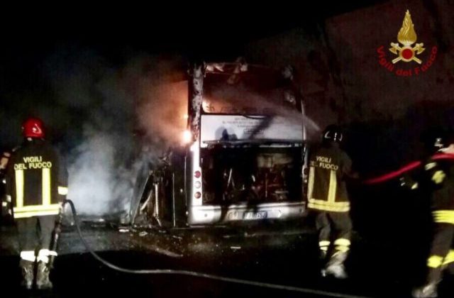L'autobus avvolto dalle fiamme con i vigili al lavoro